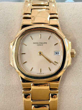 Patek Philippe Nautilus 4700/1j Ladies 26 Ivory Dial Yellow Gold PreOwned - Diamonds East Intl.