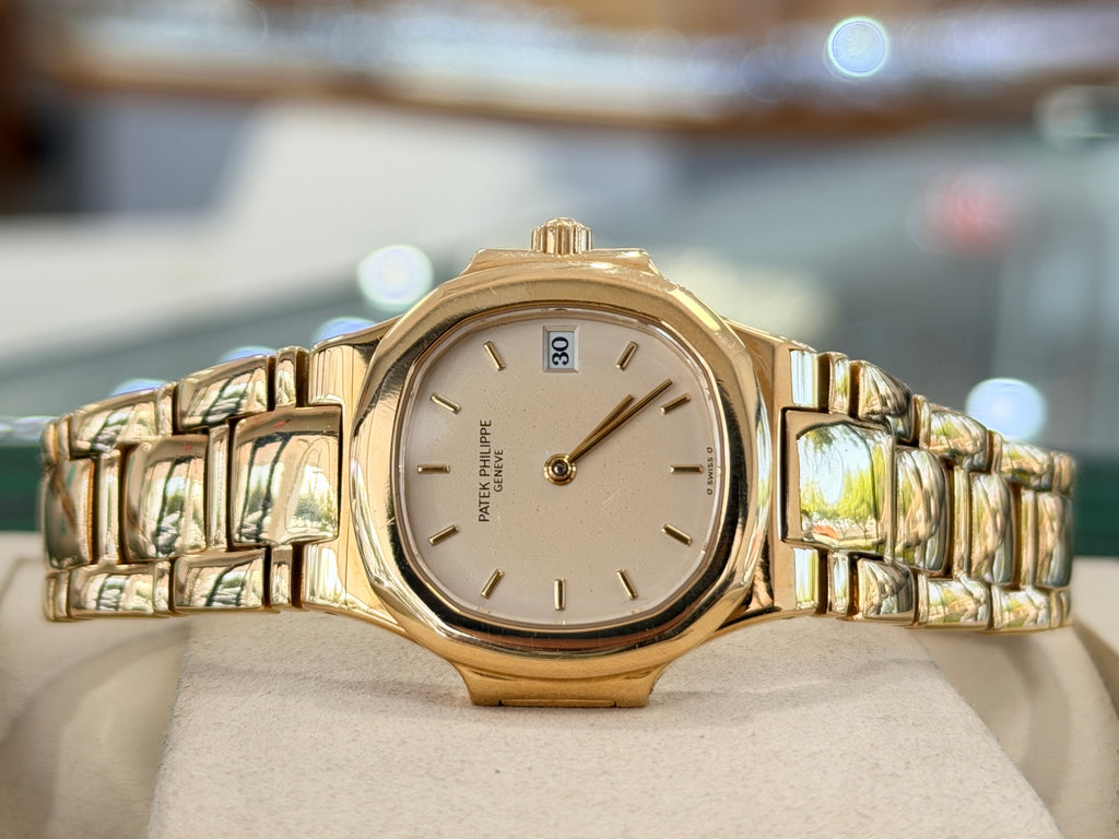 Patek Philippe Nautilus 4700/1j Ladies 26 Ivory Dial Yellow Gold PreOwned - Diamonds East Intl.