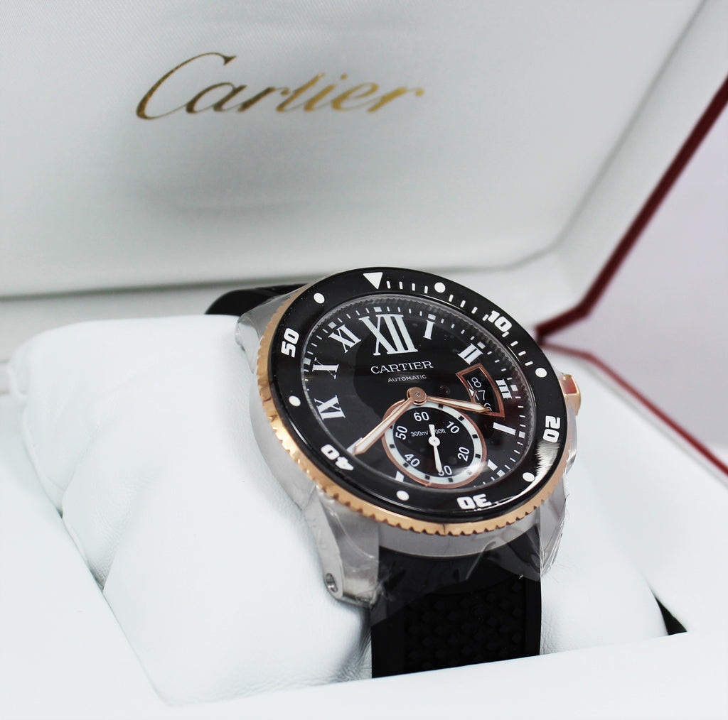Cartier Calibre De Cartier Diver W7100055 42mm Automatic 18K Rose Gold *UNWORN* Details:   Make: Cartier Model: W7100055 Calibre Condition: Unworn  Includes: The Boxes & Papers  Movement: Automatic Material: Stainless Steel 18K Rose Gold Case Size: 42mm Crystal: Sapphire Crystal  Dial: Roman Numeral Black Dial Bezel:  Cartier Factory 18K Rose Gold Diamond Bezel  Bracelet:  Cartier Black Rubber Band Clasp: Tang Buckle  Crown : 18kt rose gold crown with a flush-mounted blue spinel cabochon.  
